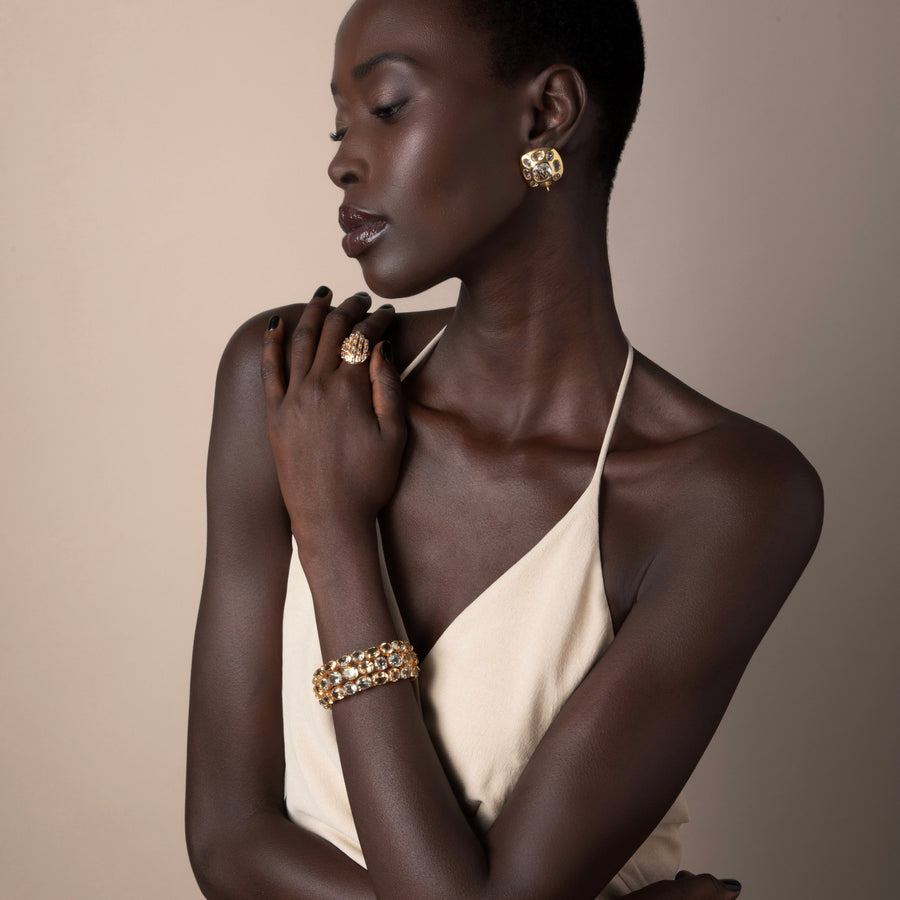 Model wearing Bounkit jewelry – Dominique Studs, Selene Ring, and Ceres Cuff in 14k gold plating with semi-precious stones, vintage Art Deco design.