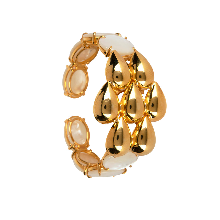 Gold cuff bracelet featuring bold teardrop motifs and lustrous pearl accents with a hinged design for an elegant fit.