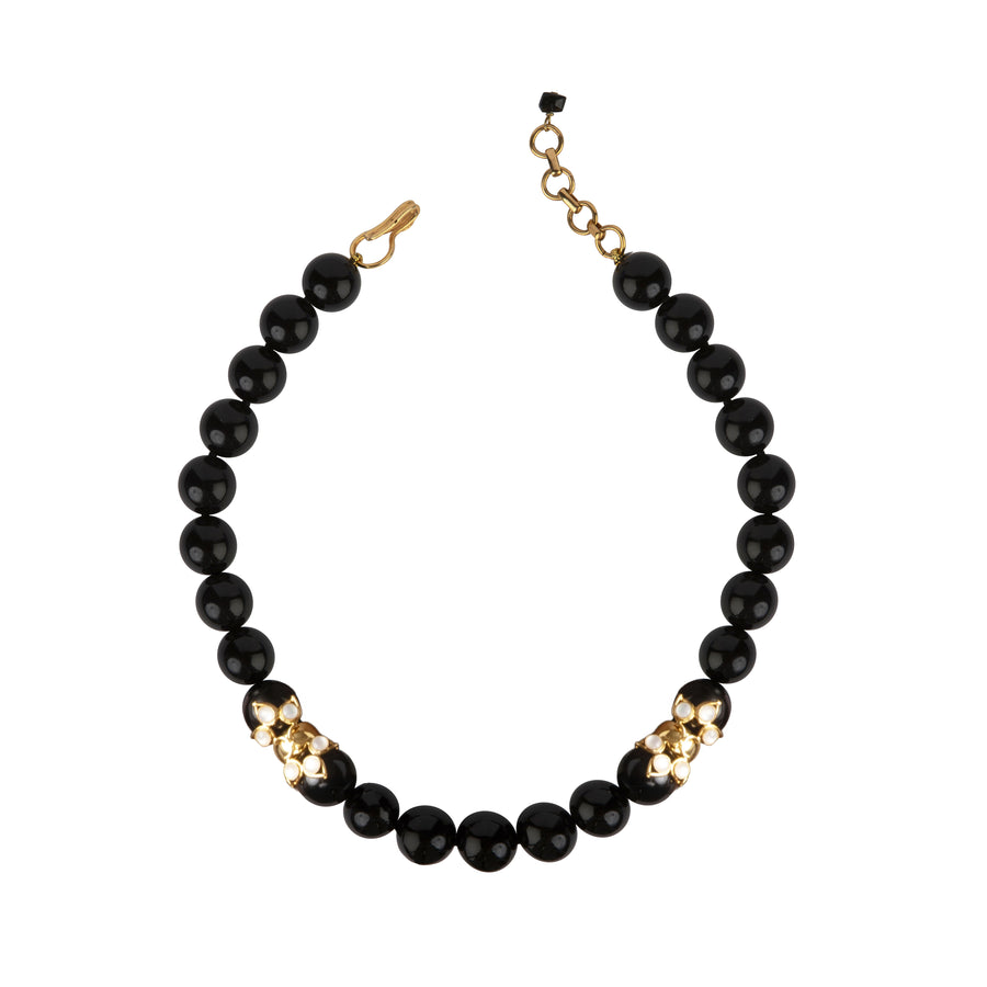 Necklace with black beads and gold accents on a white background