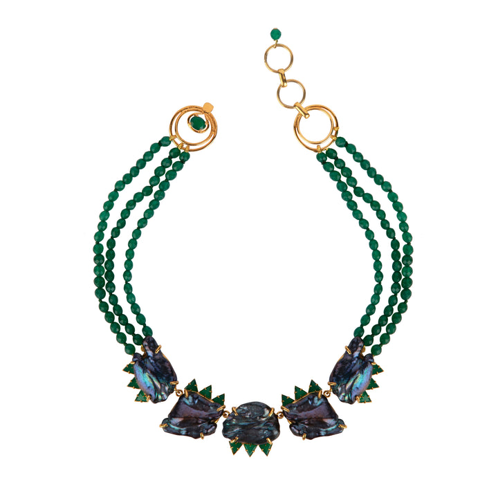 Green beaded necklace with gold accents on a white background
