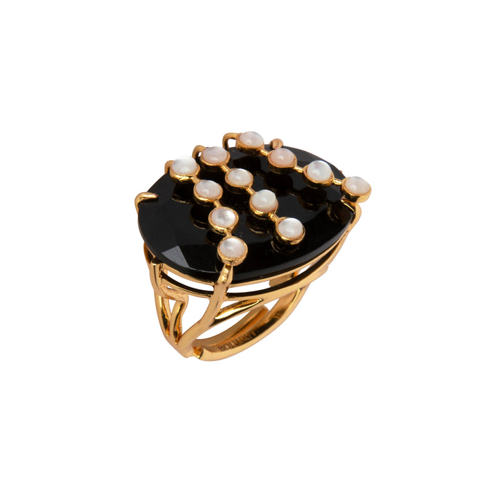Gold ring with black stone and pearls on a white background